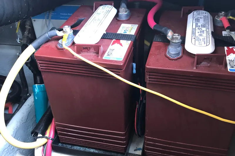 Slide: The Image of Batteries in a 2004 Mainship Pilot 30-II Sedan boat engine compartment. - 28