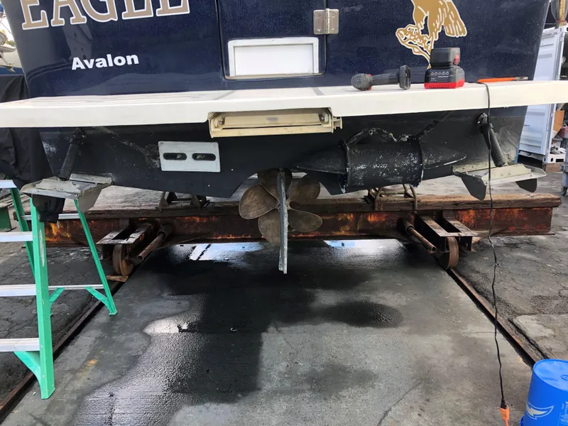 Slide: The Image of 2004 Mainship Pilot 30-II Sedan boat on dry dock, showing propeller and stern details. - 29