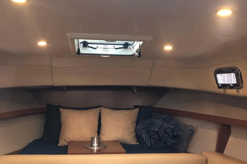 Slide: The Image of 2004 Mainship Pilot 30-II Sedan cabin interior with cushions and lighting. - 9