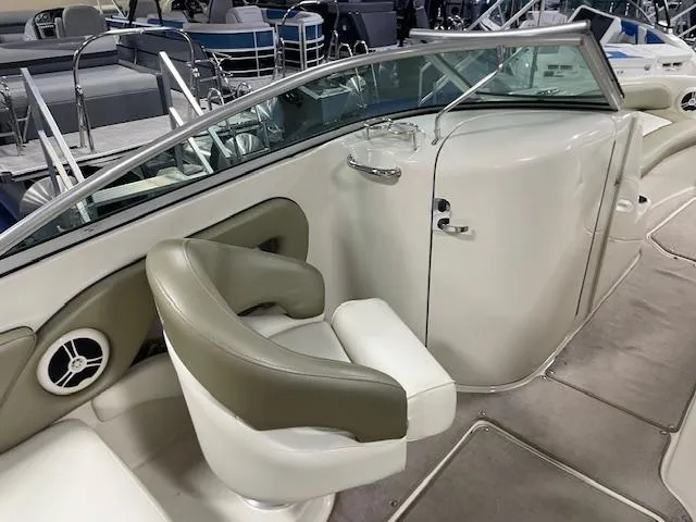 Slide: The Image of 2006 Sea Ray 240 Sundeck interior with seating and console, showcasing luxury boat design. - 4
