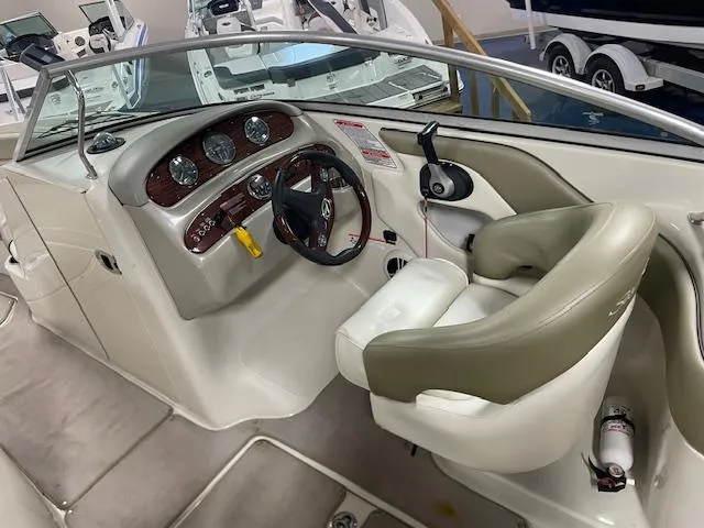 Slide: The Image of 2006 Sea Ray 240 Sundeck boat interior with steering wheel and dashboard controls. - 5