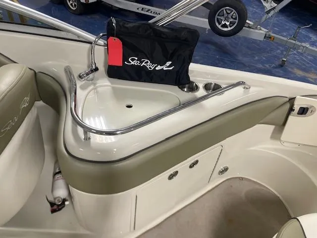 Slide: The Image of 2006 Sea Ray 240 Sundeck interior with sink and storage area. - 8