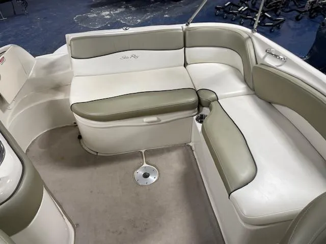 Slide: The Image of 2006 Sea Ray 240 Sundeck interior with beige and white seating arrangement. - 9