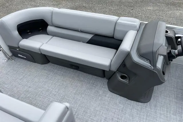 Slide: The Image of 2026 Sun Tracker Party Barge 20 DLX interior with gray seating and helm. - 10