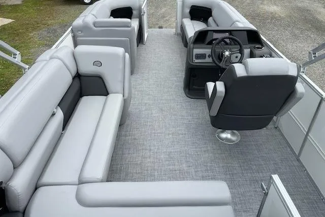 Slide: The Image of 2026 Sun Tracker Party Barge 20 DLX interior with spacious seating and modern helm. - 11