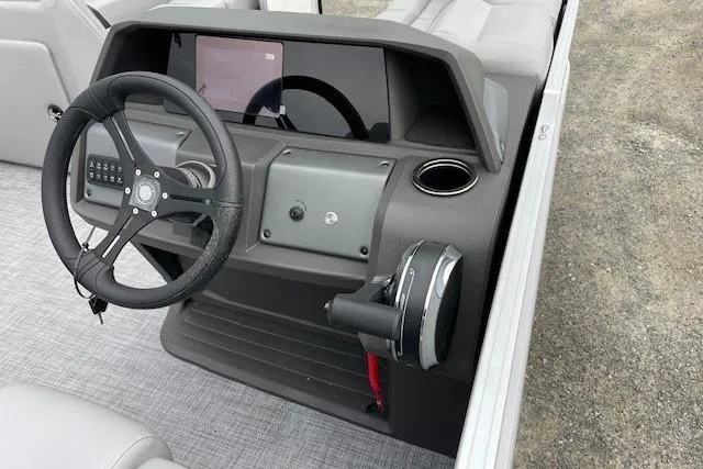 Slide: The Image of 2026 Sun Tracker Party Barge 20 DLX dashboard with steering wheel and controls. - 15