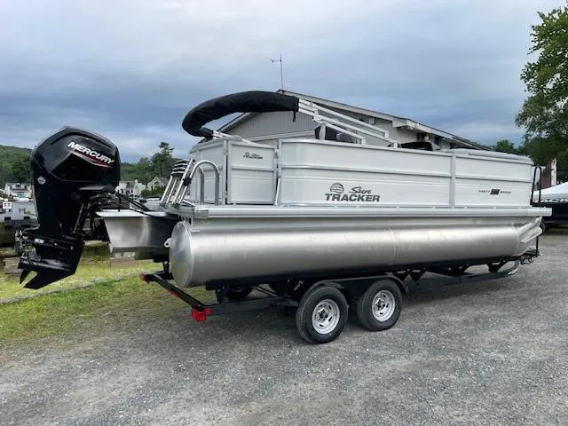 Slide: The Image of 2026 Sun Tracker Party Barge 20 DLX pontoon boat on trailer, parked outdoors. - 3
