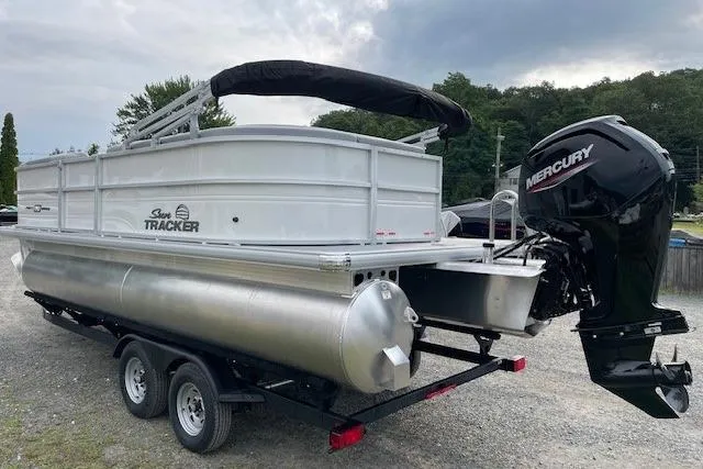 Slide: The Image of 2026 Sun Tracker Party Barge 20 DLX pontoon boat with Mercury outboard motor on trailer. - 7
