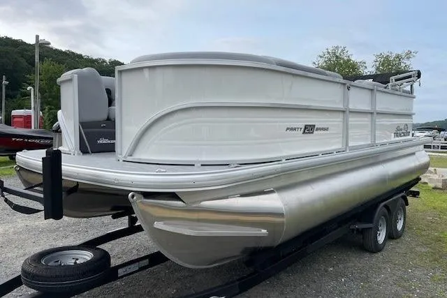 Slide: The Image of 2026 Sun Tracker Party Barge 20 DLX pontoon boat on trailer, parked outdoors. - 8