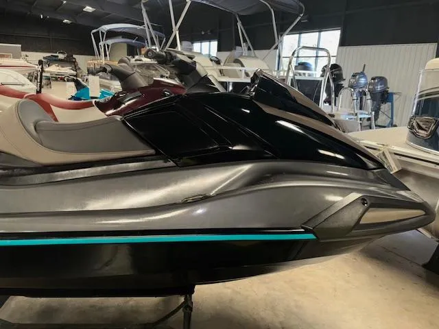 Slide: The Image of 2023 Yamaha WaveRunner VX Cruiser in showroom, sleek black design with comfortable seating. - 11