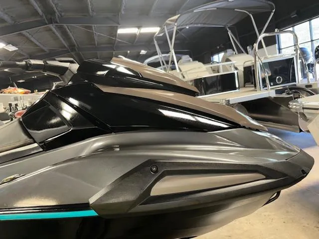 Slide: The Image of 2023 Yamaha WaveRunner VX Cruiser in showroom, sleek design with black and gray finish. - 2