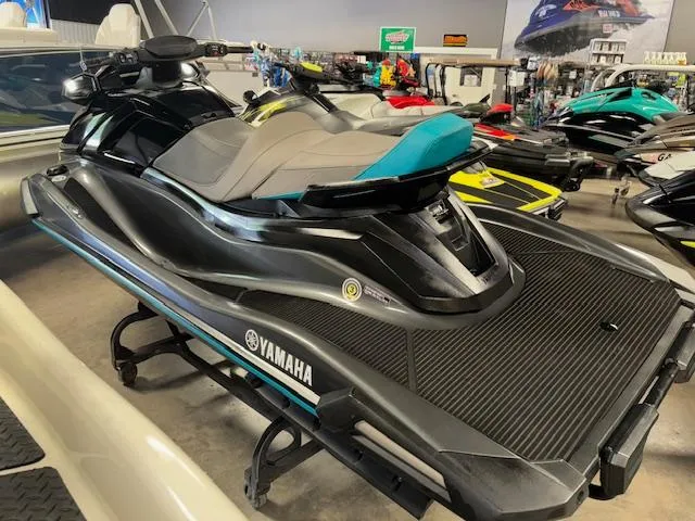 Slide: The Image of 2023 Yamaha WaveRunner VX Cruiser in showroom, sleek black design with blue accents. - 6
