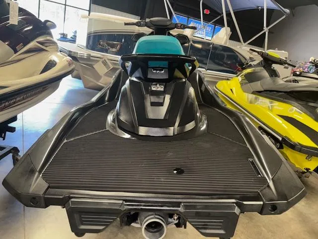 Slide: The Image of 2023 Yamaha WaveRunner VX Cruiser in showroom, rear view, black and teal design. - 7