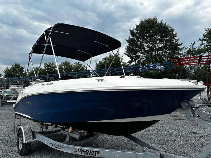 The Image of 2021 Godfrey Hurricane 205SS boat on trailer, under cloudy sky. - 0