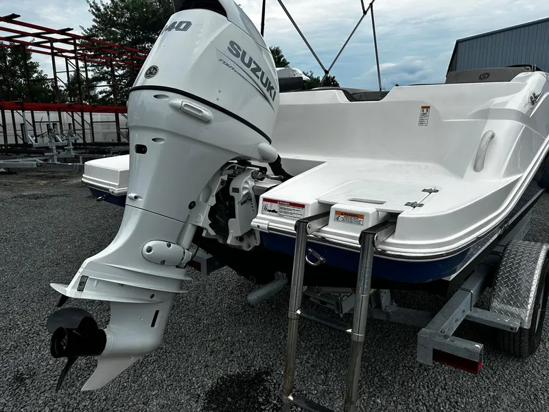 Slide: The Image of 2021 Godfrey Hurricane 205SS boat with Suzuki outboard motor on trailer. - 2