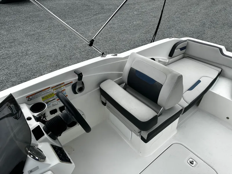 Slide: The Image of 2021 Godfrey Hurricane 205SS boat interior with steering wheel and seating area. - 4