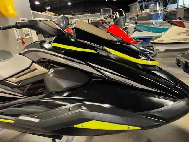 Slide: The Image of 2023 Yamaha WaveRunner FX Cruiser SVHO in showroom, sleek black design with yellow accents. - 12