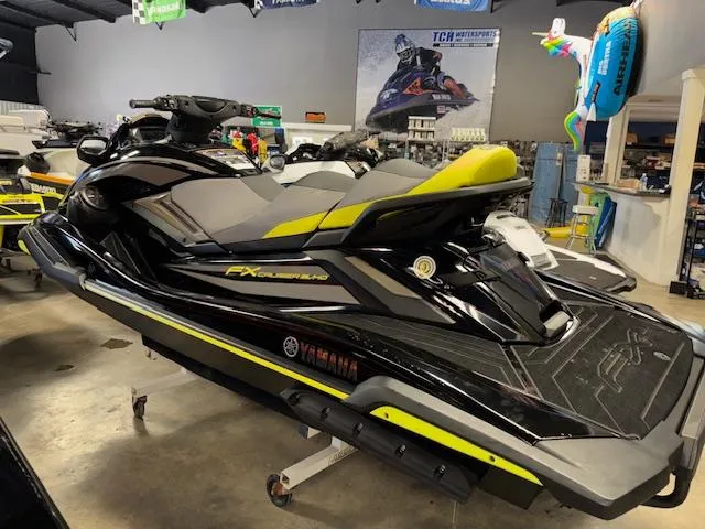 Slide: The Image of 2023 Yamaha WaveRunner FX Cruiser SVHO in showroom, black and yellow design. - 6