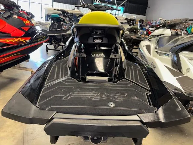 Slide: The Image of 2023 Yamaha WaveRunner FX Cruiser SVHO in showroom, rear view, black and yellow design. - 7