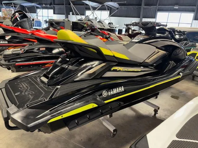 Slide: The Image of 2023 Yamaha WaveRunner FX Cruiser SVHO in showroom, black and yellow design. - 8