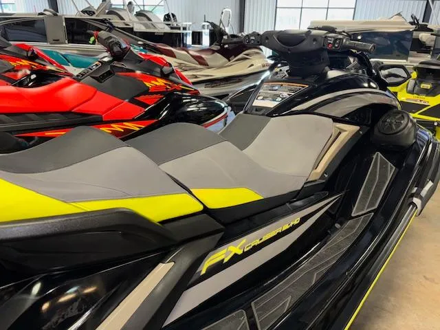 Slide: The Image of 2023 Yamaha WaveRunner FX Cruiser SVHO in showroom, sleek design with vibrant accents. - 9