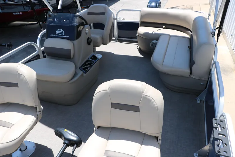 Slide: The Image of 2021 Sun Tracker Bass Buggy 16 XL interior with beige seating and steering console. - 15