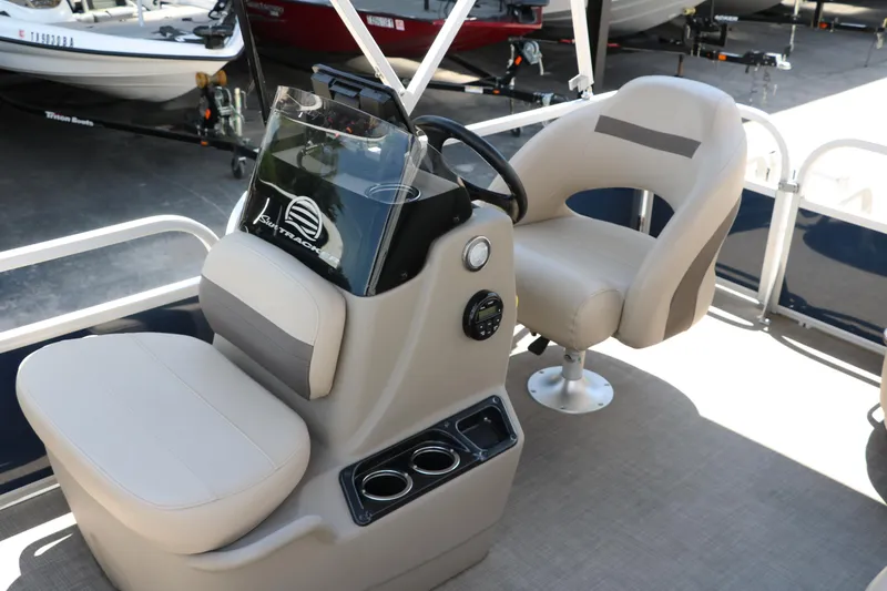 Slide: The Image of 2021 Sun Tracker Bass Buggy 16 XL interior with steering console and seating. - 16