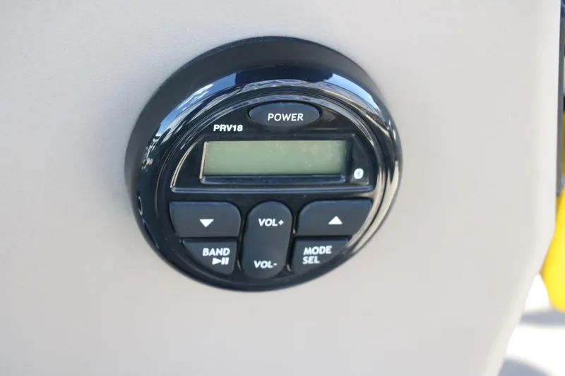 Slide: The Image of Control panel of 2021 Sun Tracker Bass Buggy 16 XL boat, featuring power and volume buttons. - 28