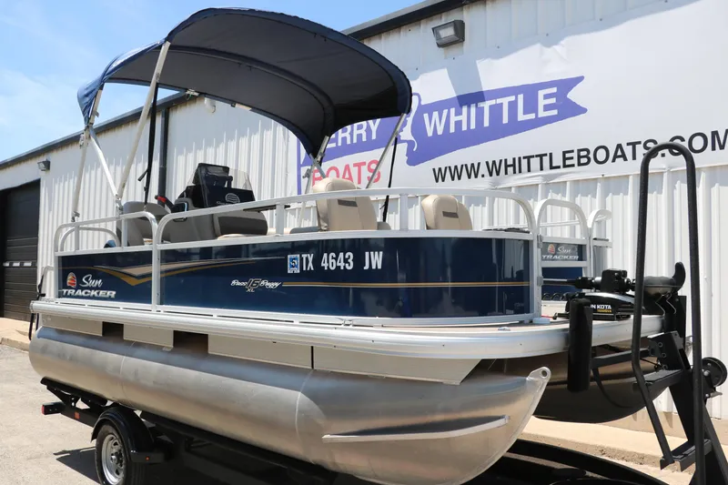 Slide: The Image of 2021 Sun Tracker Bass Buggy 16 XL pontoon boat on trailer, parked outside dealership. - 3