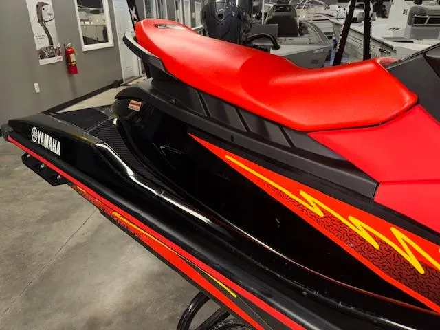 Slide: The Image of 2021 Yamaha WaveRunner EX Sport with vibrant red and black design in showroom. - 10