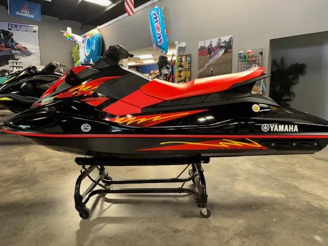 Slide: The Image of 2021 Yamaha WaveRunner EX Sport in showroom, black and red design, side view. - 16