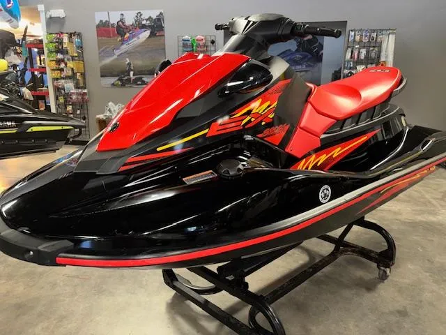Slide: The Image of 2021 Yamaha WaveRunner EX Sport in showroom, red and black design, side view. - 4
