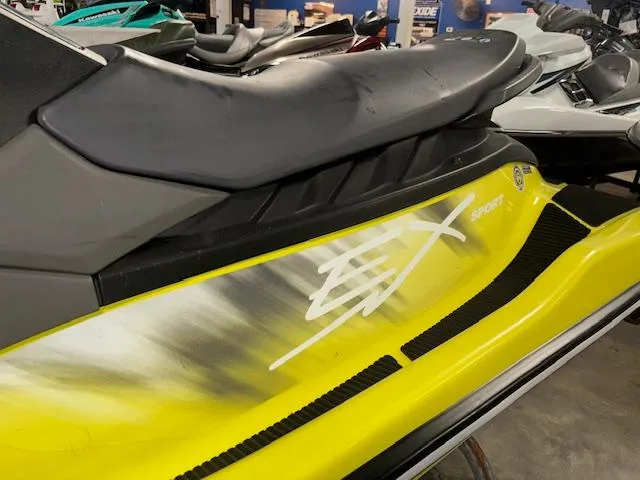 Slide: The Image of 2023 Yamaha WaveRunner EX Sport, yellow and black, side view in showroom. - 4