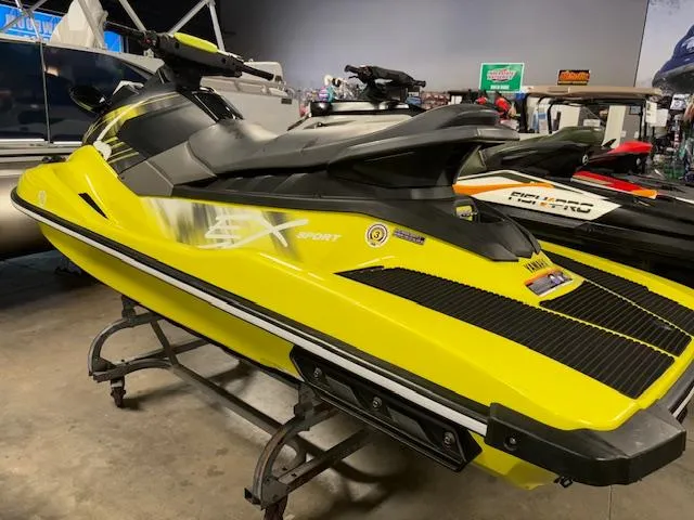 Slide: The Image of 2023 Yamaha WaveRunner EX Sport in vibrant yellow, displayed indoors on a stand. - 5