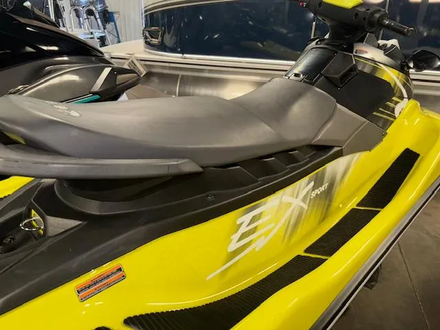 Slide: The Image of 2023 Yamaha WaveRunner EX Sport in vibrant yellow, side view in showroom. - 7