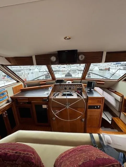 Slide: The Image of 1978 Hatteras 58 Cockpit Motor Yacht helm with wooden steering wheel and navigation equipment. - 10