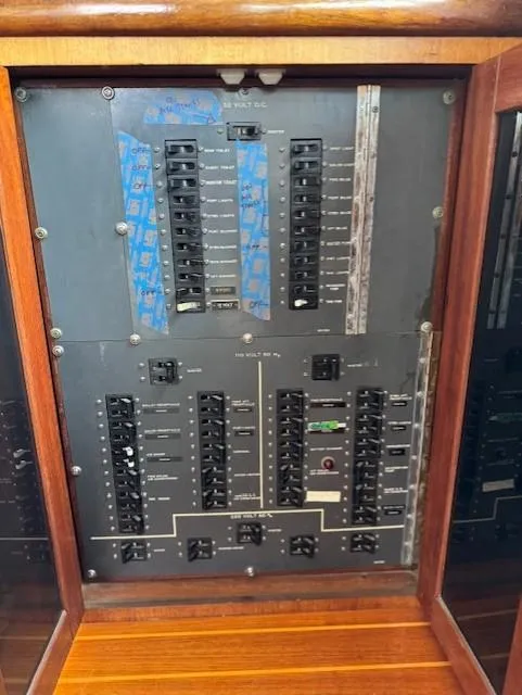 Slide: The Image of Electrical panel of a 1978 Hatteras 58 Cockpit Motor Yacht with circuit breakers. - 16