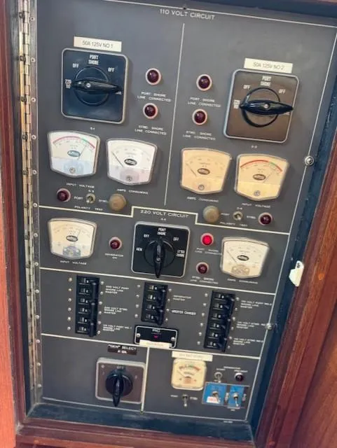 Slide: The Image of Electrical panel of a 1978 Hatteras 58 Cockpit Motor Yacht, featuring various switches and gauges. - 17