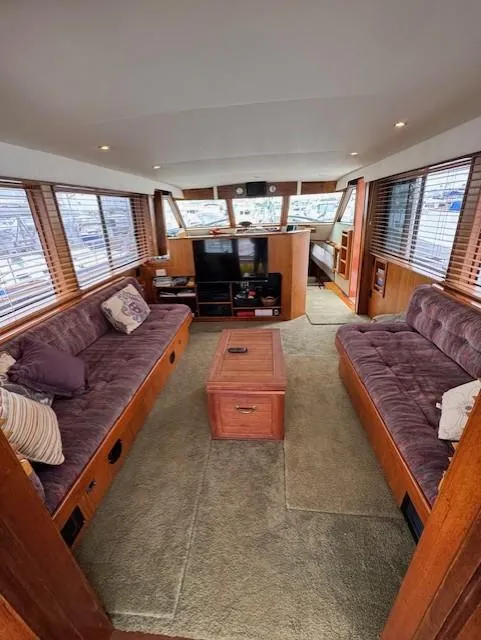 Slide: The Image of Interior of 1978 Hatteras 58 Cockpit Motor Yacht with plush seating and wooden accents. - 19