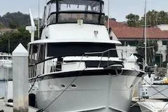 Slide: The Image of 1978 Hatteras 58 Cockpit Motor Yacht docked at a marina. - 2