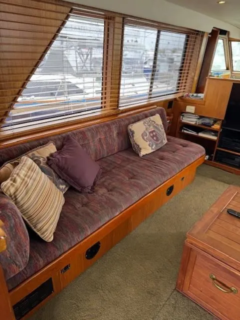 Slide: The Image of Interior of 1978 Hatteras 58 Cockpit Motor Yacht with cozy seating and wooden accents. - 20
