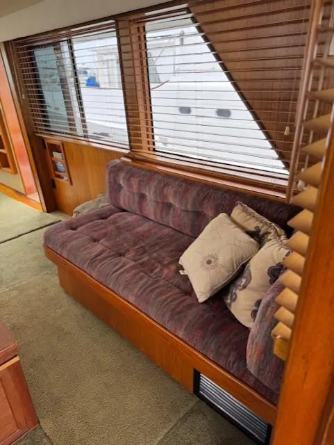 Slide: The Image of Interior of 1978 Hatteras 58 Cockpit Motor Yacht with plush sofa and decorative pillows. - 21