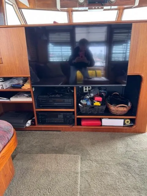 Slide: The Image of Interior of 1978 Hatteras 58 Cockpit Motor Yacht with TV and storage shelves. - 22