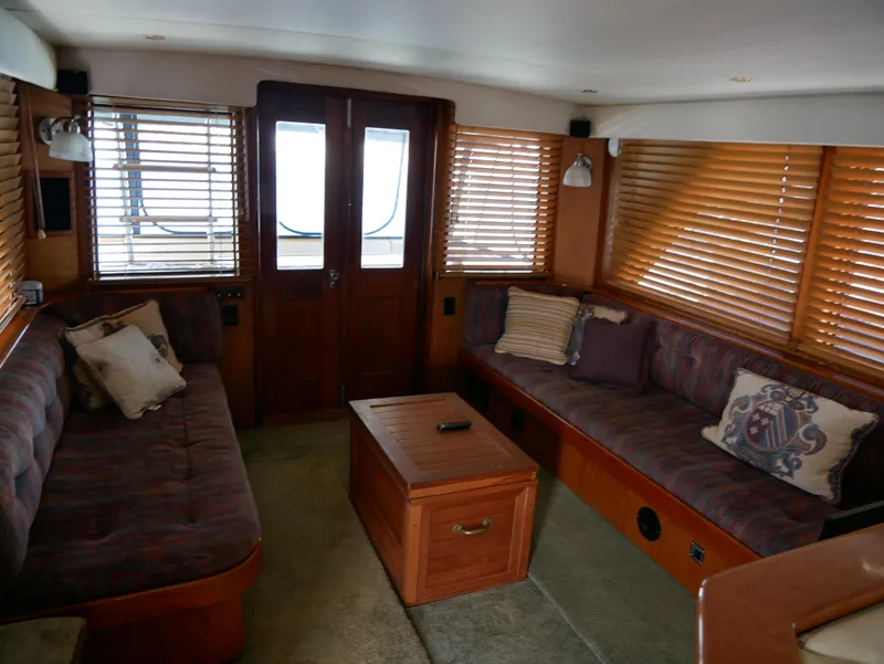 Slide: The Image of Interior of 1978 Hatteras 58 Cockpit Motor Yacht with cozy seating and wooden blinds. - 23