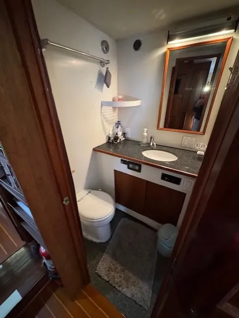 Slide: The Image of Bathroom interior of 1978 Hatteras 58 Cockpit Motor Yacht with sink and toilet. - 26