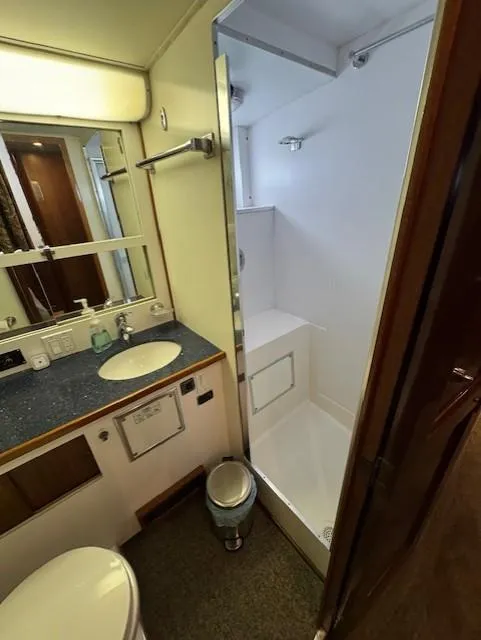 Slide: The Image of 1978 Hatteras 58 Cockpit Motor Yacht bathroom with shower, sink, and mirror. - 29