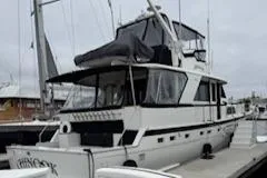 Slide: The Image of 1978 Hatteras 58 Cockpit Motor Yacht docked at marina. - 3