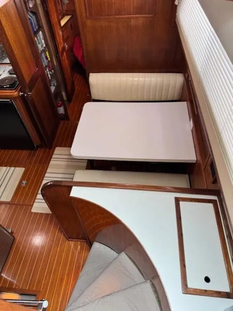 Slide: The Image of Interior of 1978 Hatteras 58 Cockpit Motor Yacht with wood finish and dining area. - 35