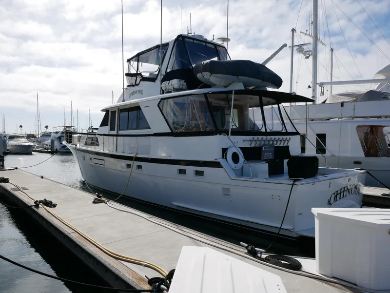 Slide: The Image of 1978 Hatteras 58 Cockpit Motor Yacht docked at marina under cloudy sky. - 4