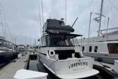 Slide: The Image of 1978 Hatteras 58 Cockpit Motor Yacht docked at marina under cloudy skies. - 5